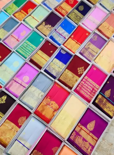 Wedding Kanchipuram silk sarees with rich gold zari in traditional bridal colors.